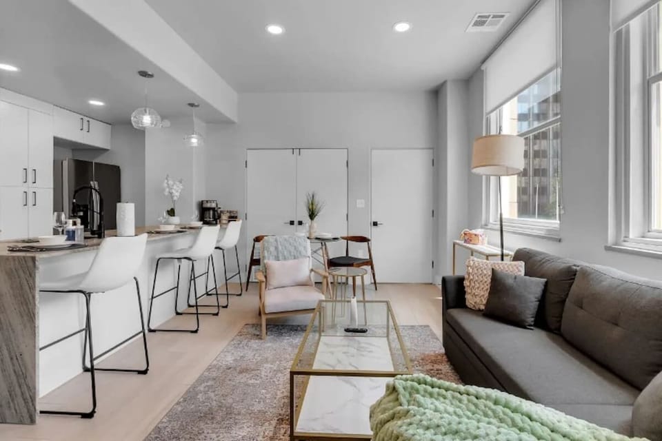 Bright living area with a cozy couch and smart TV.