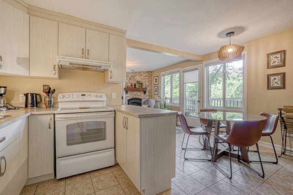 View from kitchen toward dining area showing access doors to balcony