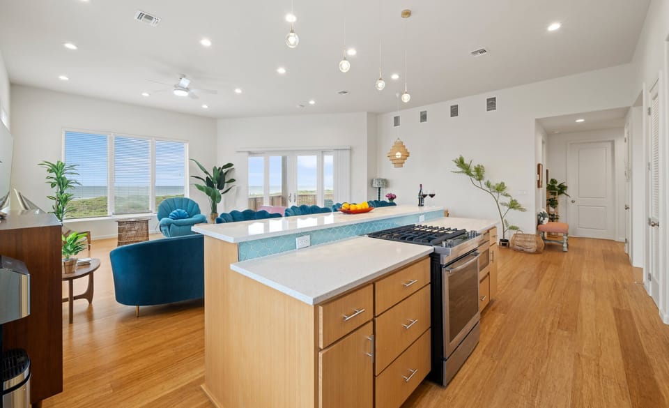 Kitchen Island — Gas Cooktop, Quartz Counter, Teal Scallop Stools & Ocean View