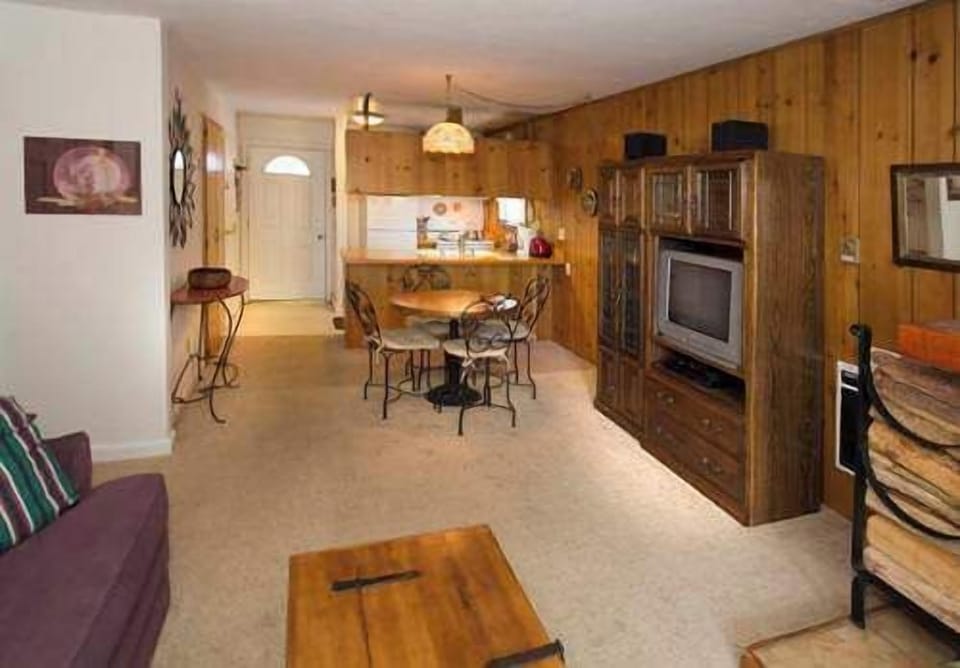Living room w TV and balcony access