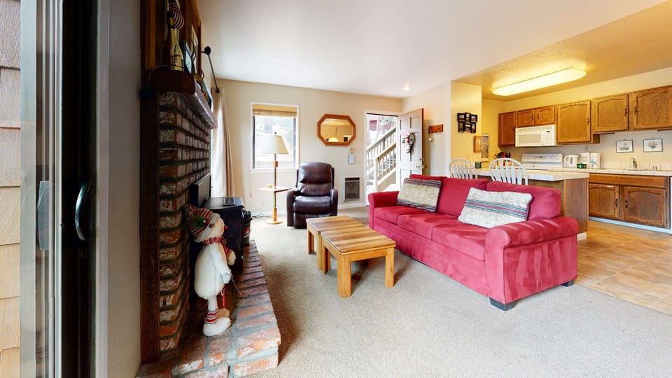 Living room with sofa sleeper, flat screen TV, and fireplace