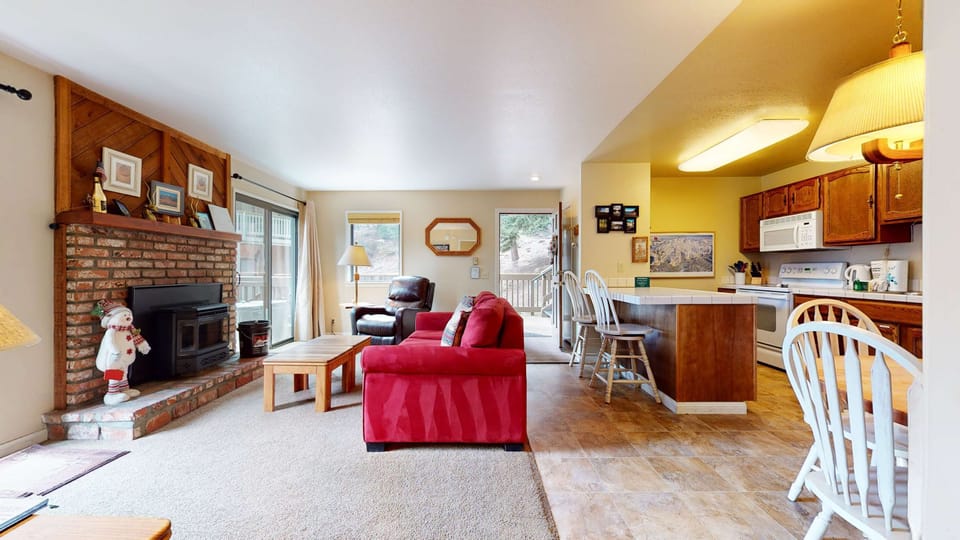 Living room with sofa sleeper, flat screen TV, and fireplace