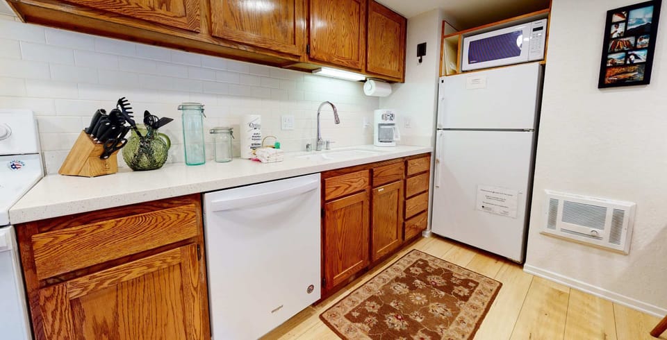 Kitchen with toaster, drip coffee maker, blender, electric stovetop and more