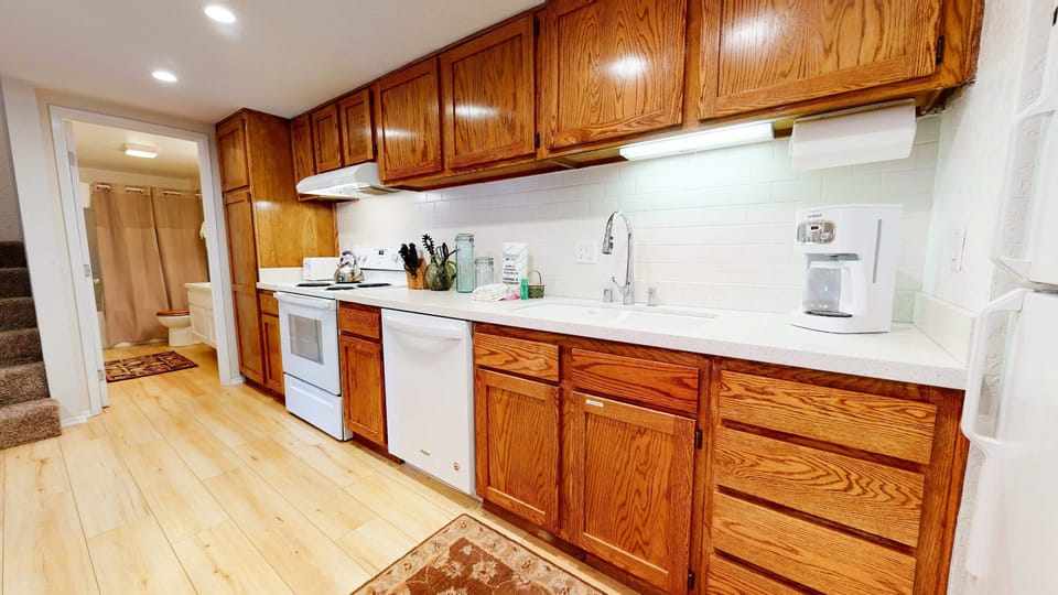 Kitchen with toaster, drip coffee maker, blender, electric stovetop and more