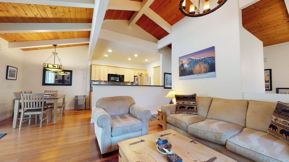Cozy living space with fireplace, TV, and deck access