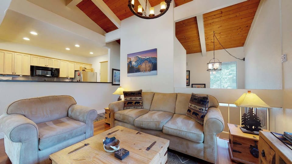 Cozy living space with fireplace, TV, and deck access