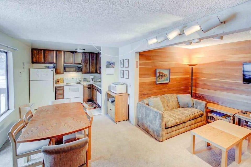 Living room w/ flat screen TV, wood burning fireplace, DVD player