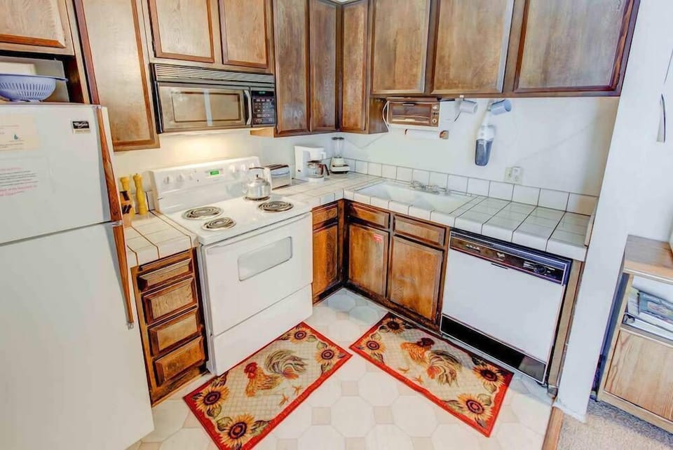 Kitchen w/ toaster, drip coffee pot, blender, wine opener, pots, pans and more