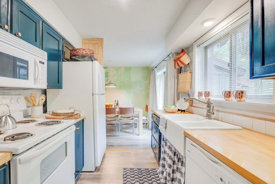 Your charming galley kitchen awaits, blending modern convenience with coastal-inspired style—perfect for preparing meals before a day of adventure.