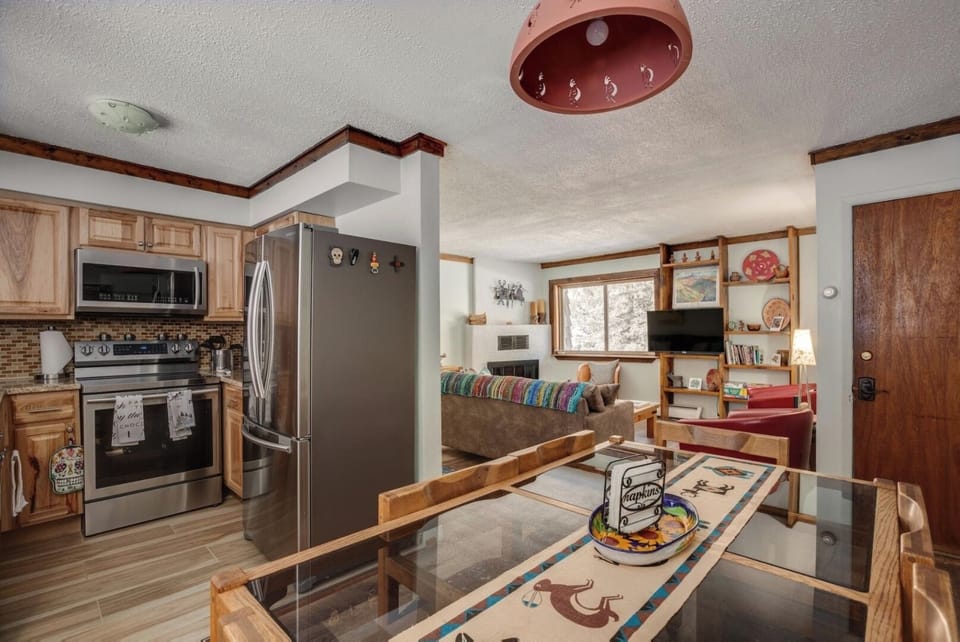 Step into your cozy retreat where rustic wood finishes and modern touches blend seamlessly. Enjoy preparing meals in your fully equipped kitchen, then gather at the inviting dining table or unwind on the plush sofa, surrounded by warm décor.