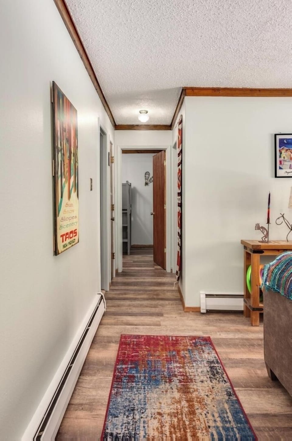 Step inside your welcoming hallway with warm wood accents and vibrant décor that sets the tone for a comfortable mountain getaway.