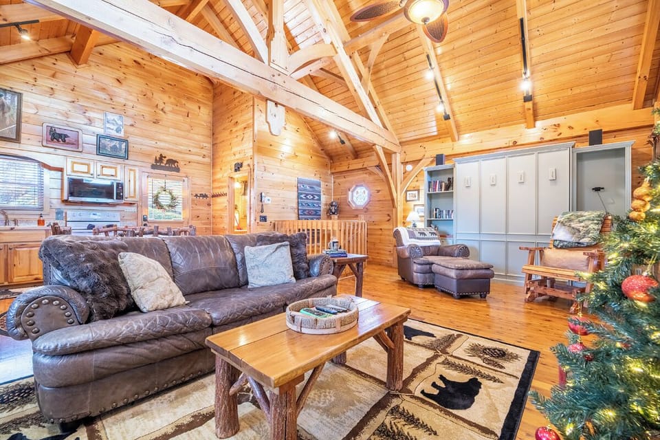 Cozy up in this rustic log cabin living room where leather sofas and exposed beams create your perfect mountain retreat atmosphere.