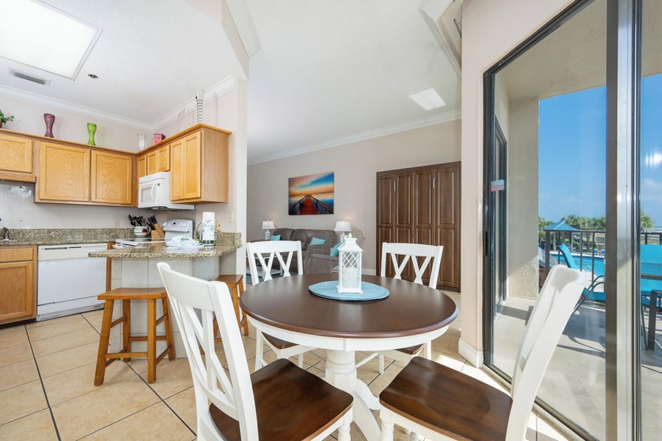 Gather around the round dining table, enjoying views through sliding glass doors that lead to the balcony