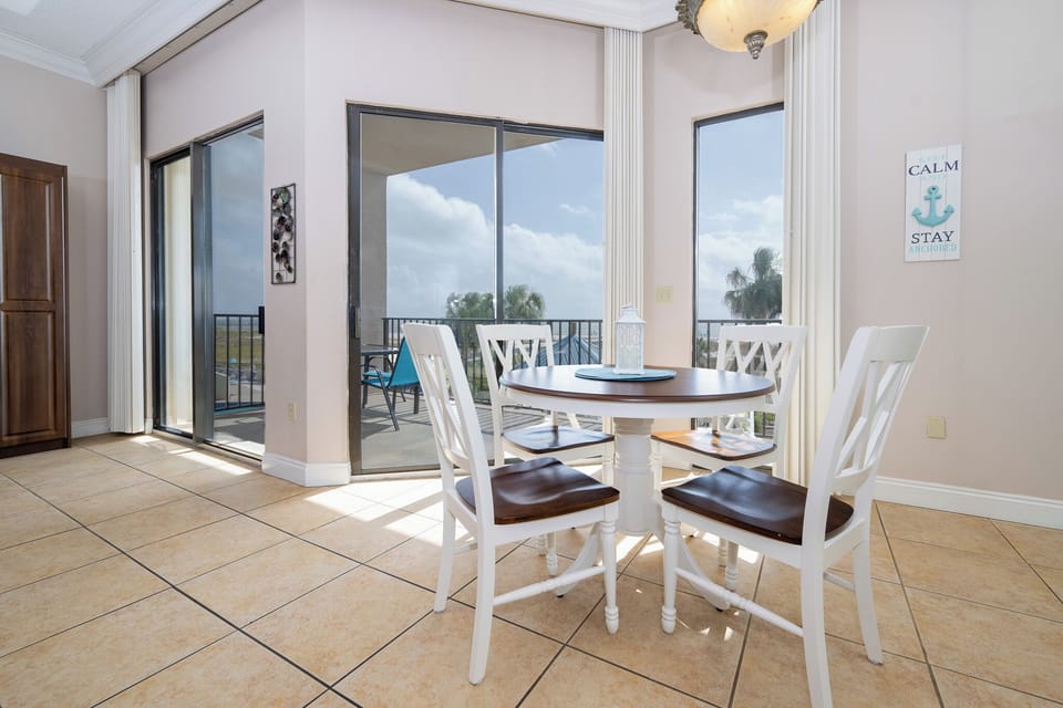 Dine at the round table while enjoying views through the sliding glass doors that open to the balcony