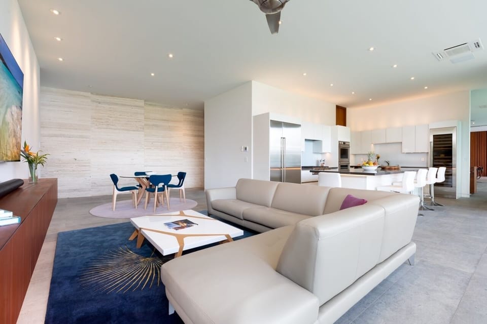 Luxuriously spacious media room flows into a modern kitchen, perfect for social gatherings.