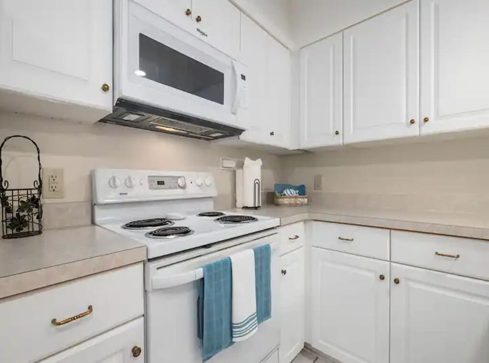The kitchen is fully stocked with all of the dinnerware and cookware 