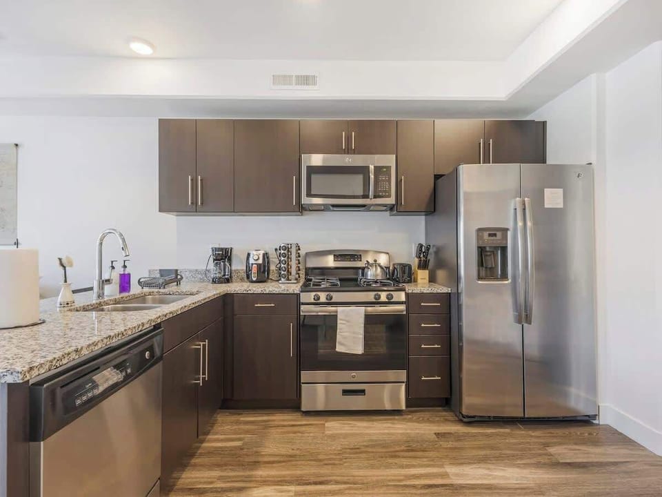 Sleek kitchen w/ stainless steel appliances & spacious granite countertops
