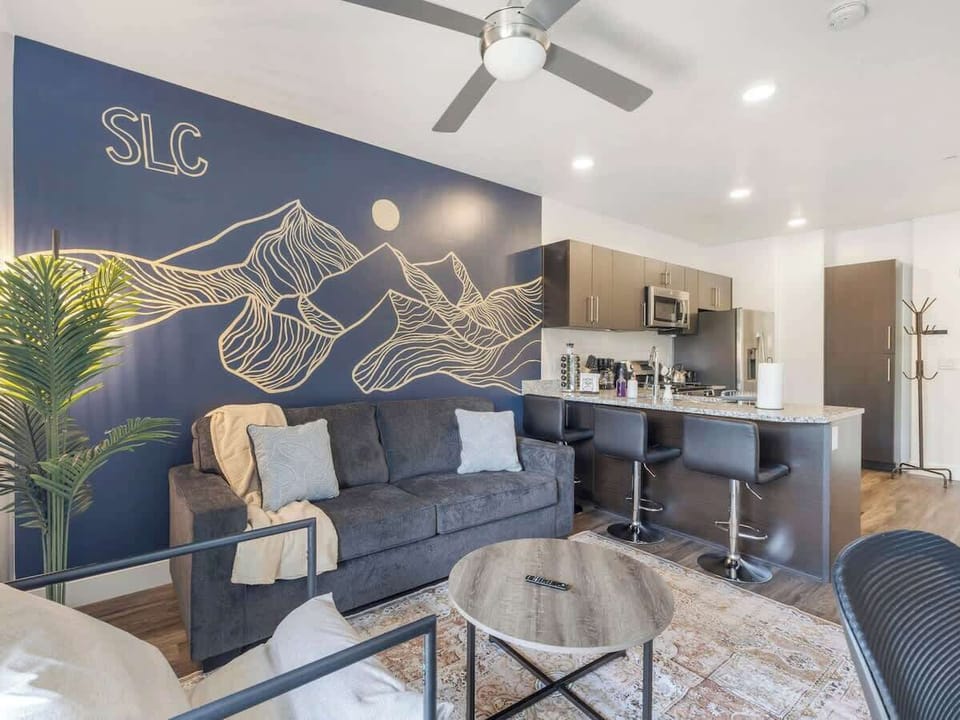 Inviting living room w/ bar seating, modern decor, & open layout for easy gathering