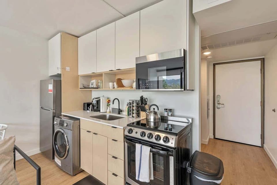 Well-equipped kitchenette w/ appliances, coffee setup & sleek finishes