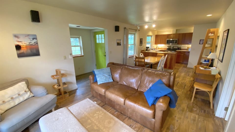 You'll walk into an open concept home where the formal living room, dining area and kitchen are all balanced perfectly in one space with peekaboo water views. 