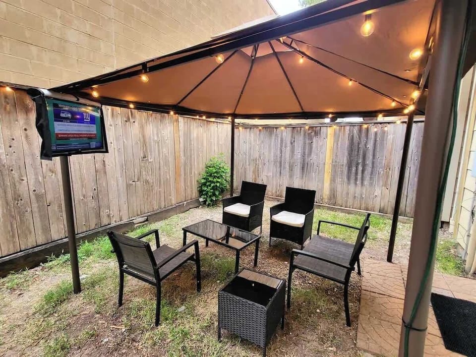 Dine alfresco beneath the umbrella in your tranquil outdoor space.