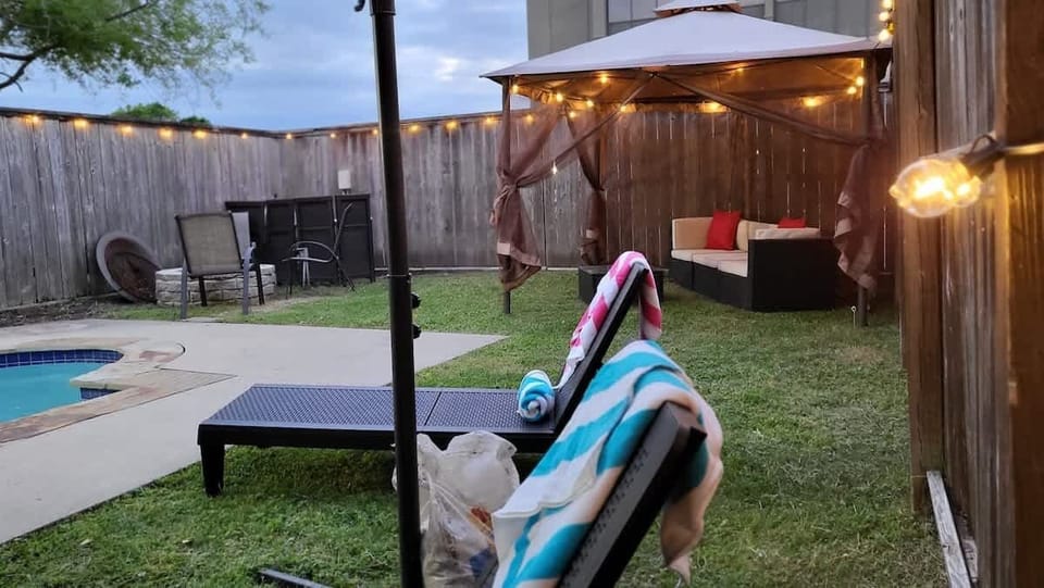 Backyard ready for sunbathing, laughter, and refreshing afternoon dips.