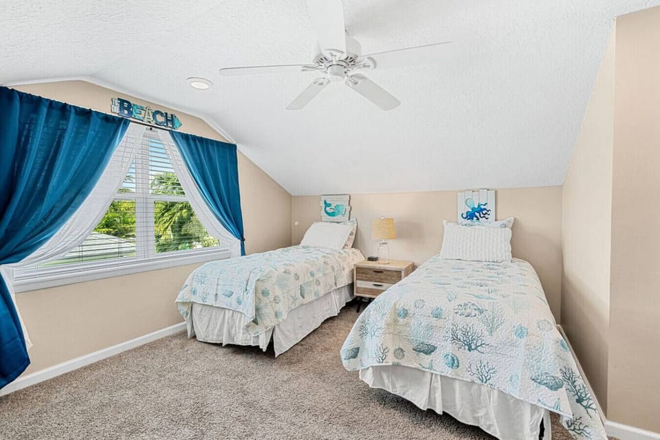 Upstairs bedroom with two twin beds.