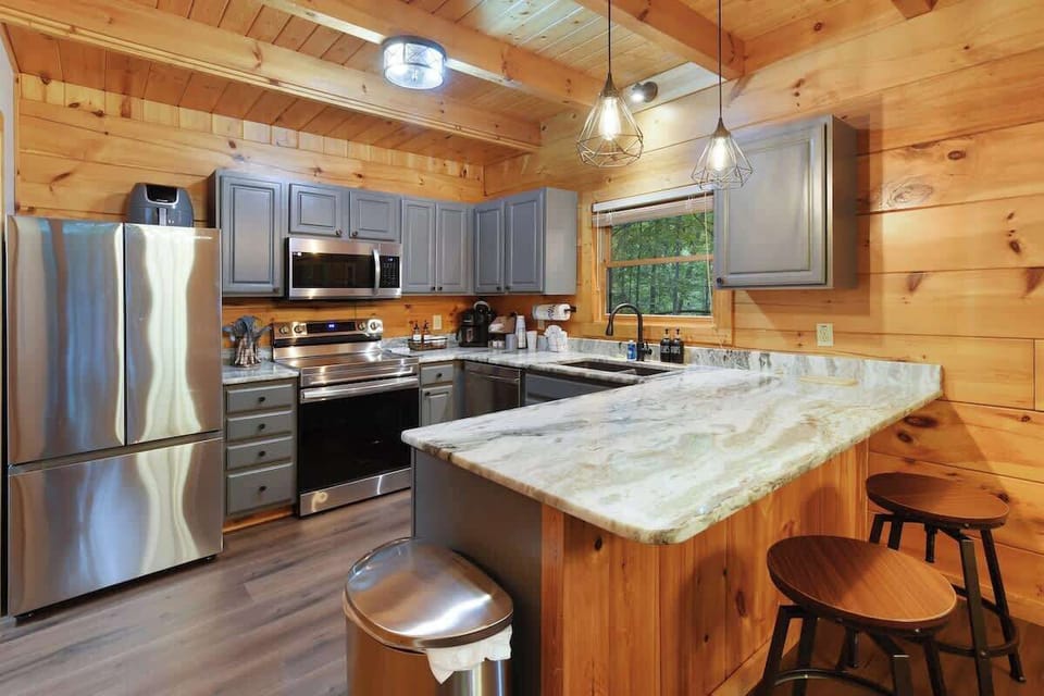 Rustic kitchen with marble countertops and stainless steel appliances