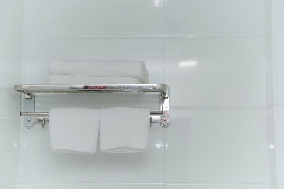 Shower, hair dryer, slippers, towels