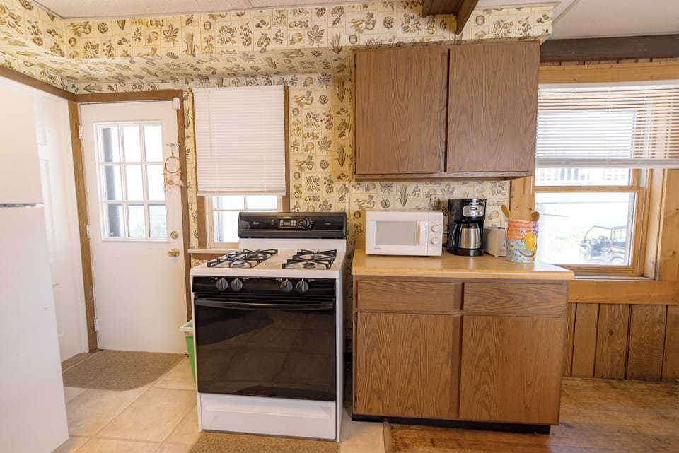 If you want to cook your meals, there is a full size stove.  
The door is the exit to the side yard.