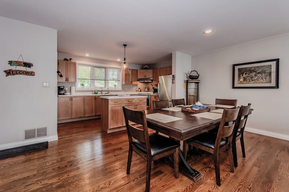 An open-concept dining area flows seamlessly into the fully-equipped kitchen, perfect for gathering with friends and family.