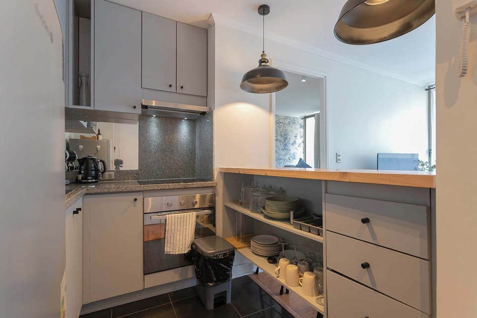 Modern kitchen with sleek cabinetry and ample storage, perfect for preparing meals during your stay.