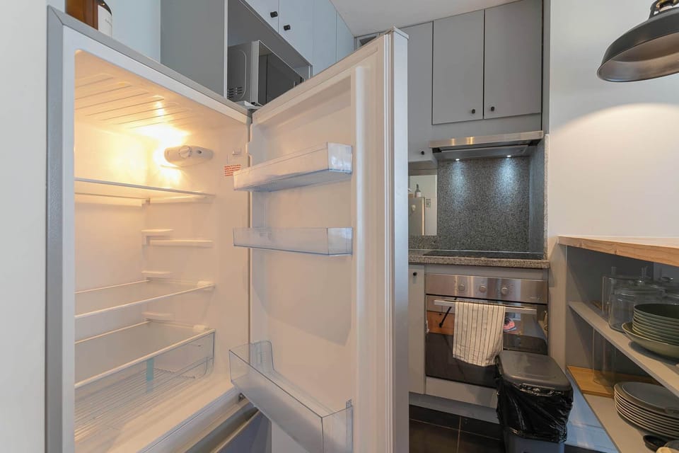 Compact kitchen with modern appliances and ample storage, perfect for preparing meals during your stay.