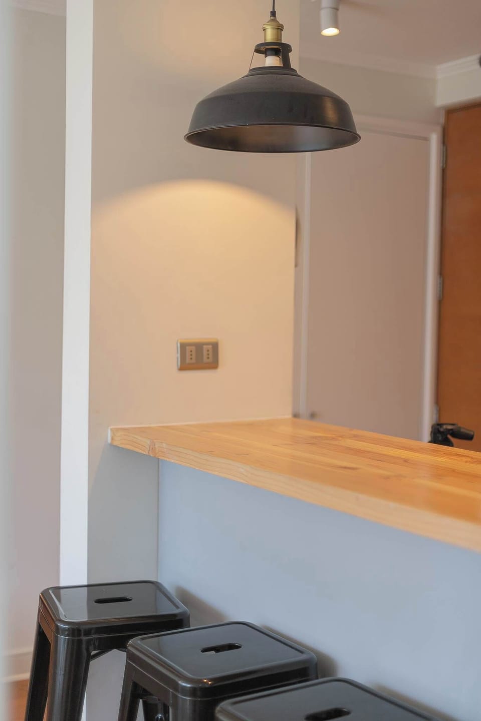 Cozy breakfast bar with modern stools and ambient lighting, perfect for morning coffee or evening chats.