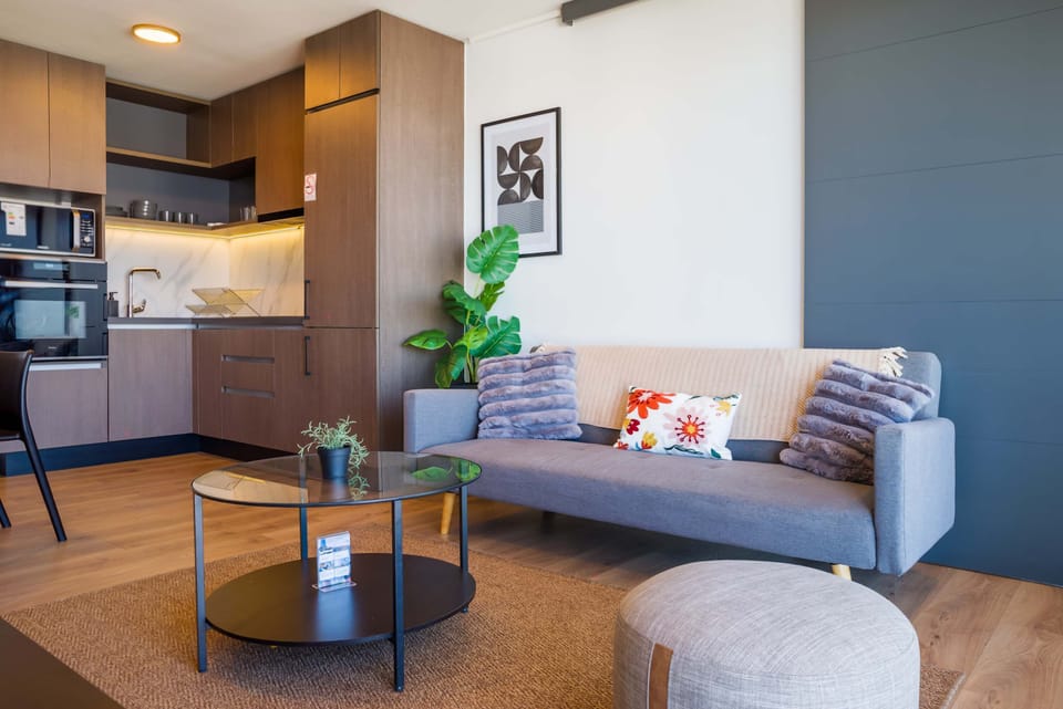 Cozy living area with modern kitchen, perfect for relaxing after exploring the city.