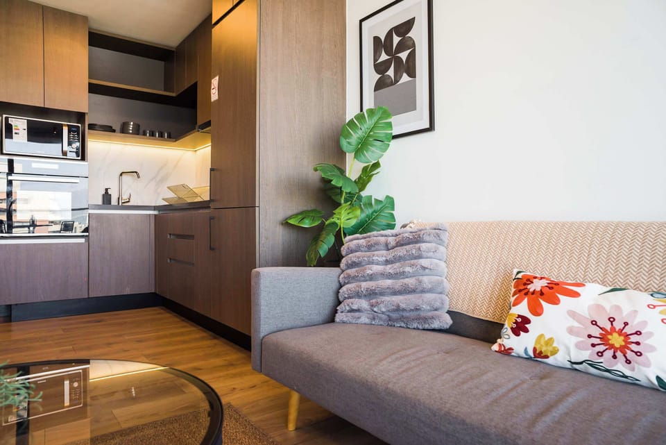 Cozy living area with modern kitchen, perfect for relaxing after exploring the city.