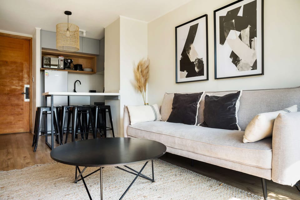 Chic and cozy living space with modern decor and a convenient kitchenette, perfect for relaxing after exploring the city.