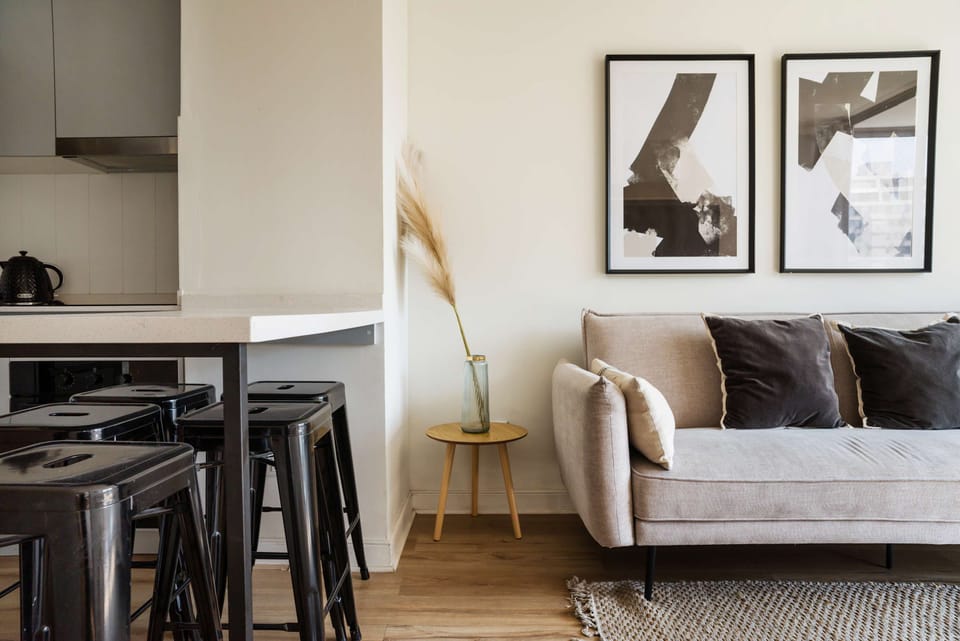 Cozy living space with modern decor and a convenient kitchen counter, perfect for relaxation and dining.
