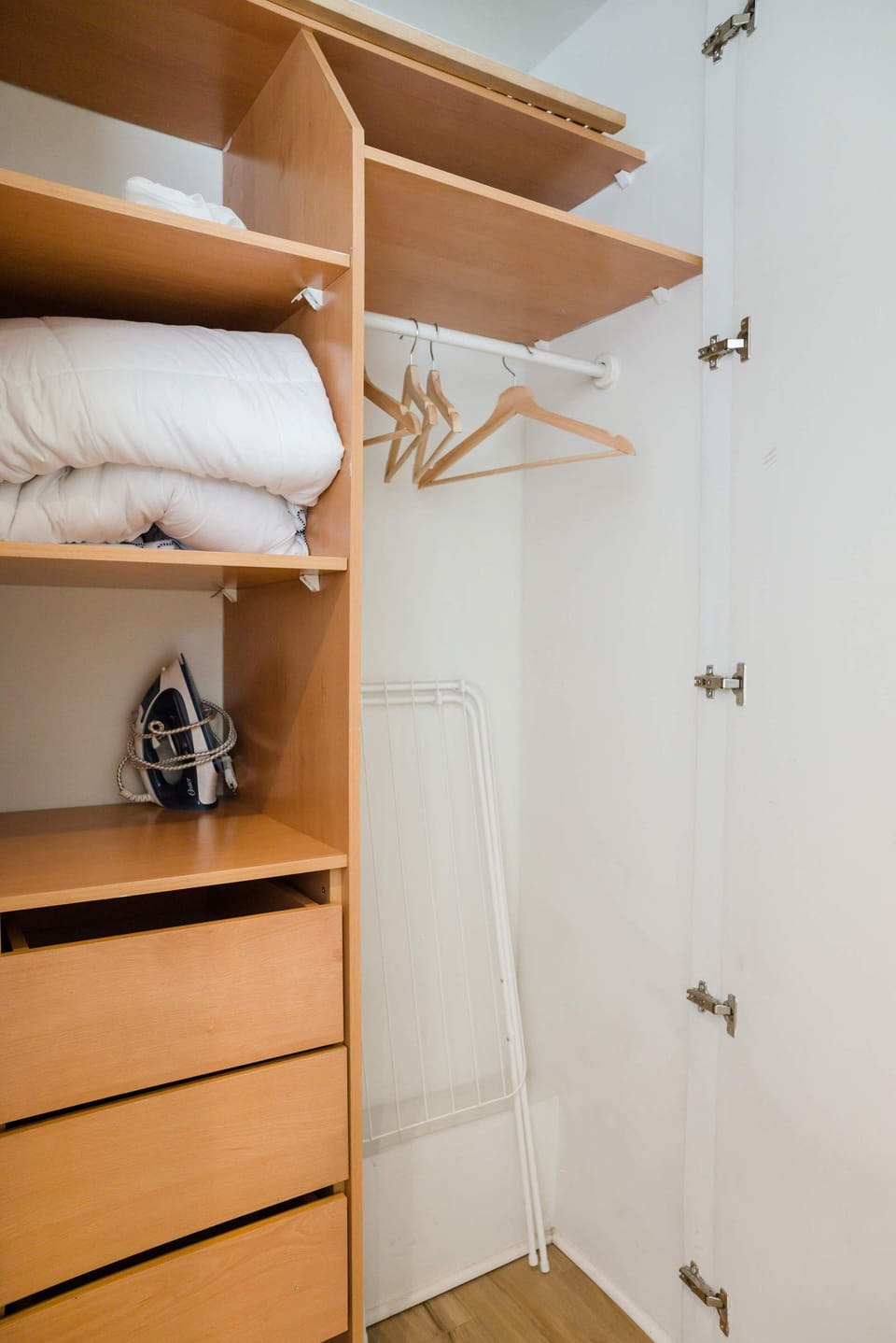 Spacious closet with ample storage, hangers, and essentials for a comfortable stay.