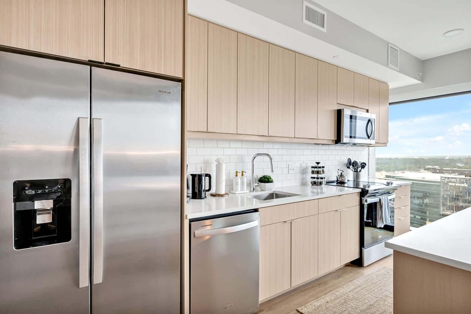 Kitchen with cooking essentials including microwave, oven, ice machine, dishwasher
