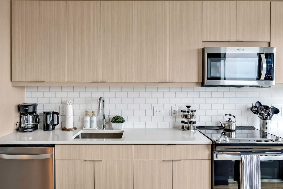 Kitchen with cooking essentials including microwave, oven, ice machine, dishwasher