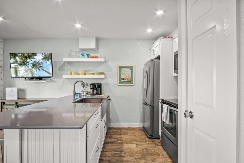 Cook up a storm in this fully stocked kitchen featuring sleek stainless steel appliances—perfect for preparing everything from quick snacks to gourmet meals!