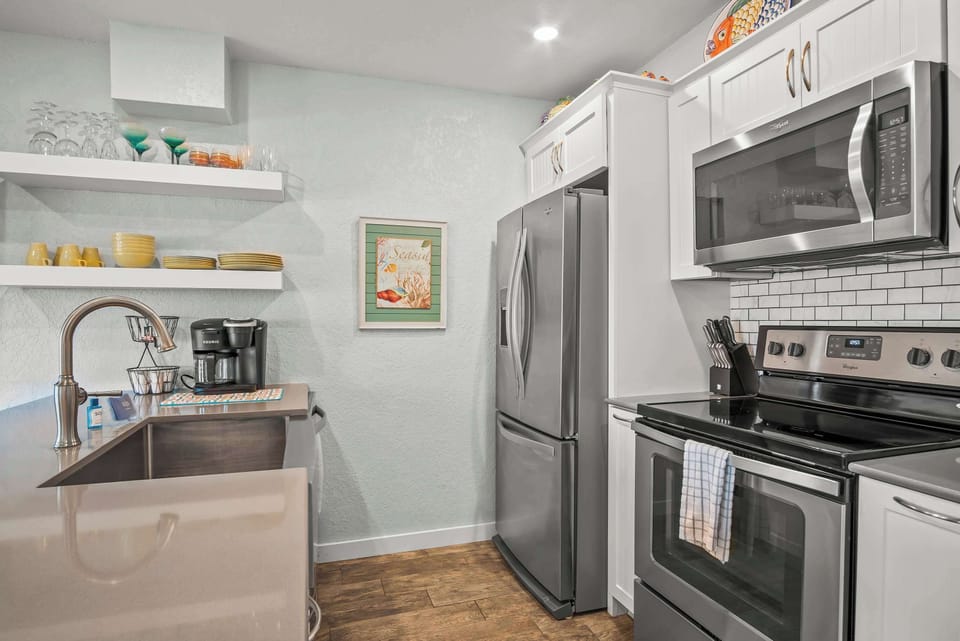 Cook up a storm in this fully stocked kitchen featuring sleek stainless steel appliances—perfect for preparing everything from quick snacks to gourmet meals!