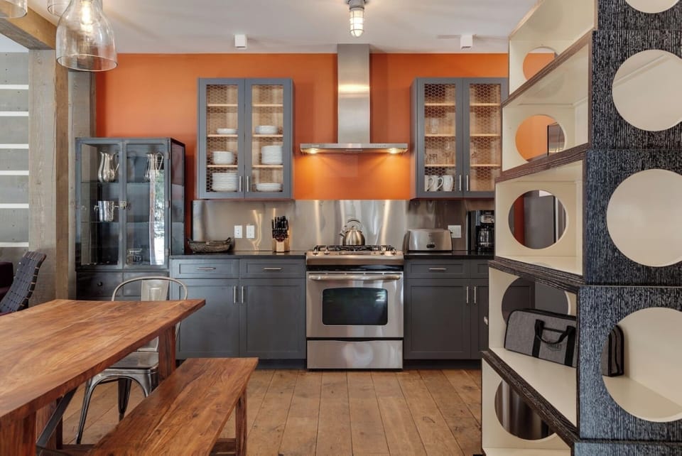 Your stylish kitchen awaits with stainless steel appliances, modern cabinetry, and a warm dining space perfect for home-cooked meals and morning coffee.