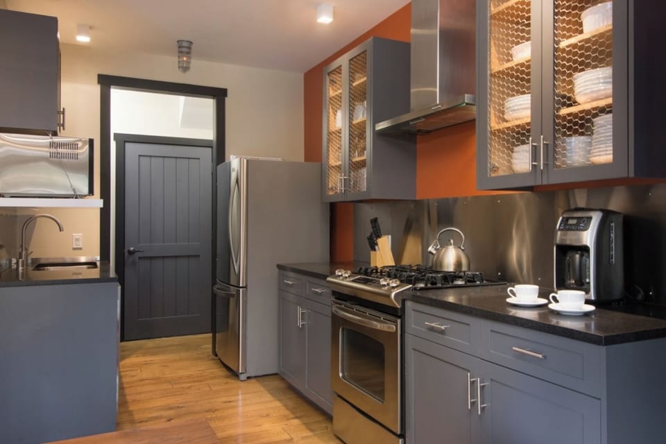 Your fully equipped kitchen awaits with sleek cabinetry, stainless steel appliances, and a cozy coffee station ready to fuel your mornings. Warm wood floors and modern finishes make meal prep feel effortless.