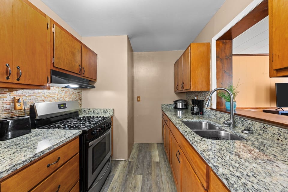 Kitchen features modern stainless steel appliances for style.
