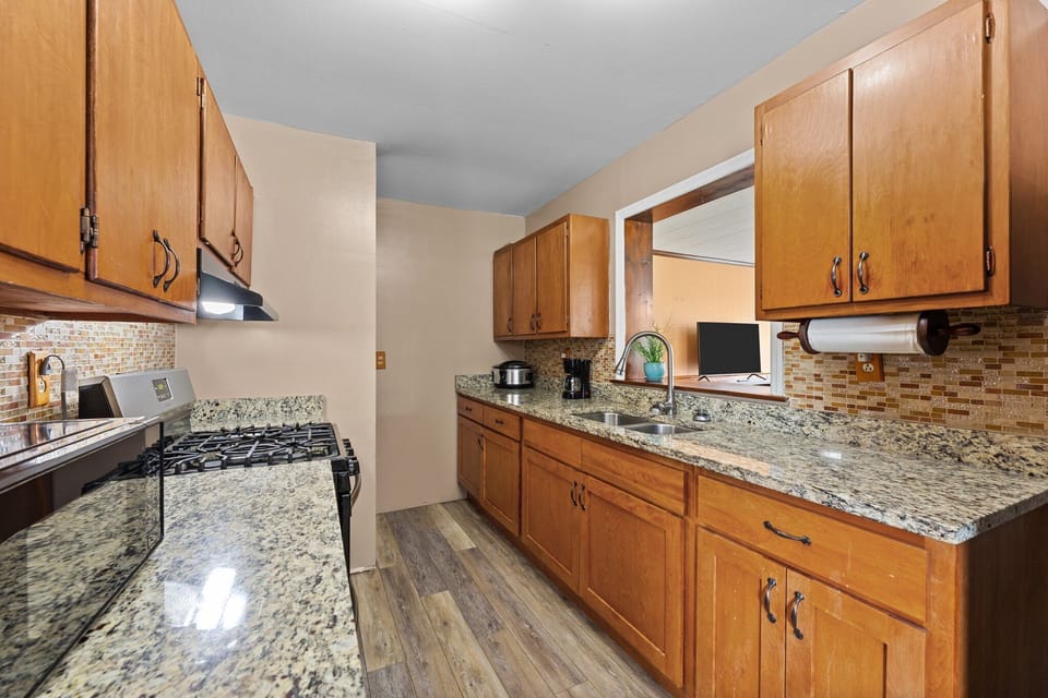 Kitchen includes a 5-cup coffee maker, toaster, microwave, and gas stove.