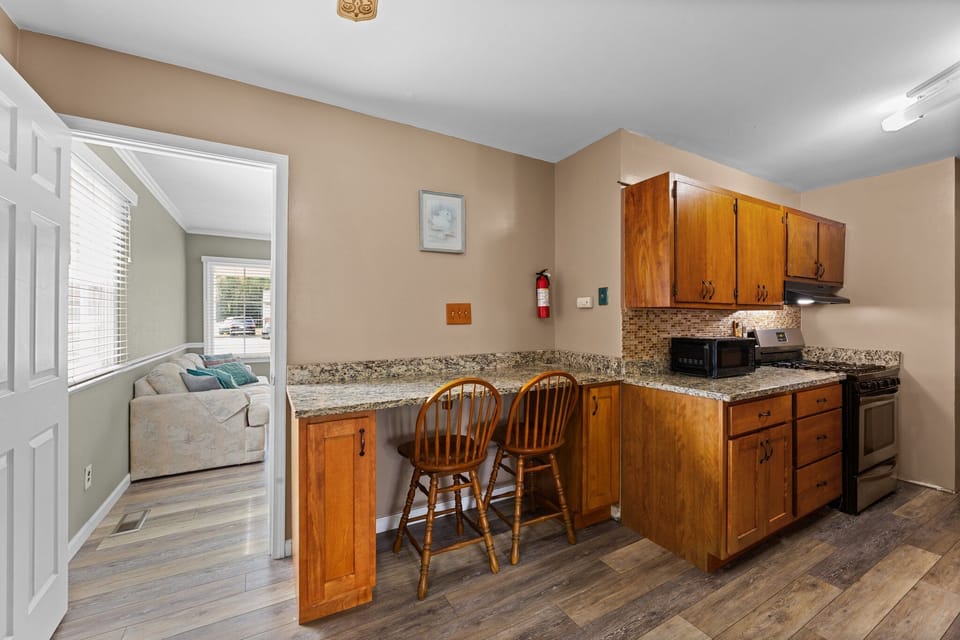Two-top bar area in the kitchen serves as dining or workspace.