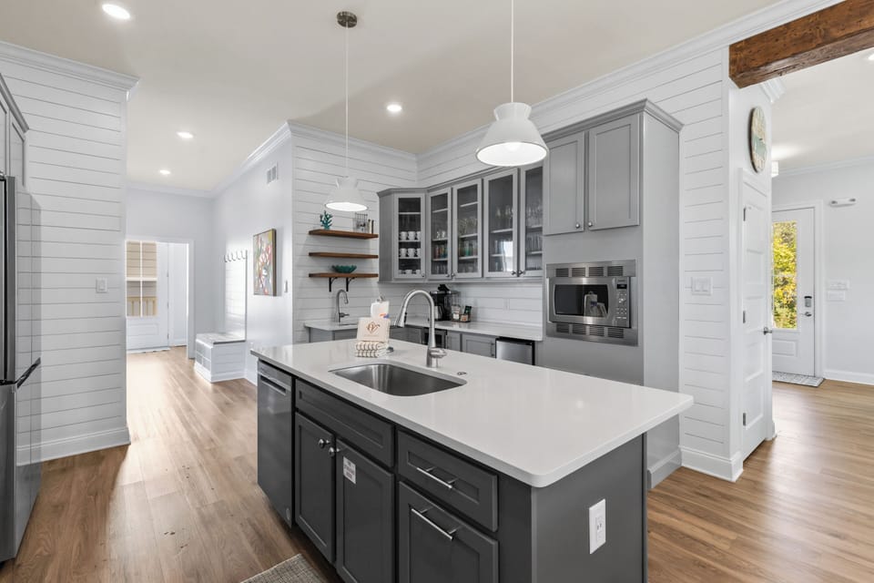 Your gourmet kitchen awaits with gleaming countertops, modern appliances, and a spacious island perfect for cooking memorable meals together.