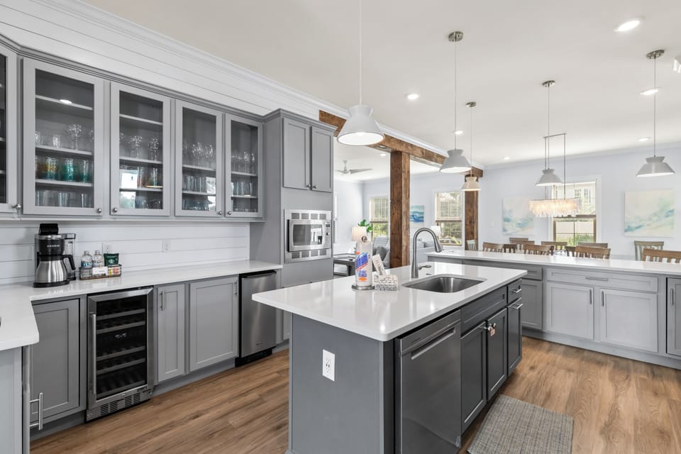 Your gourmet kitchen awaits with sleek gray cabinetry, gleaming quartz countertops, and top-tier appliances perfect for creating memorable meals.